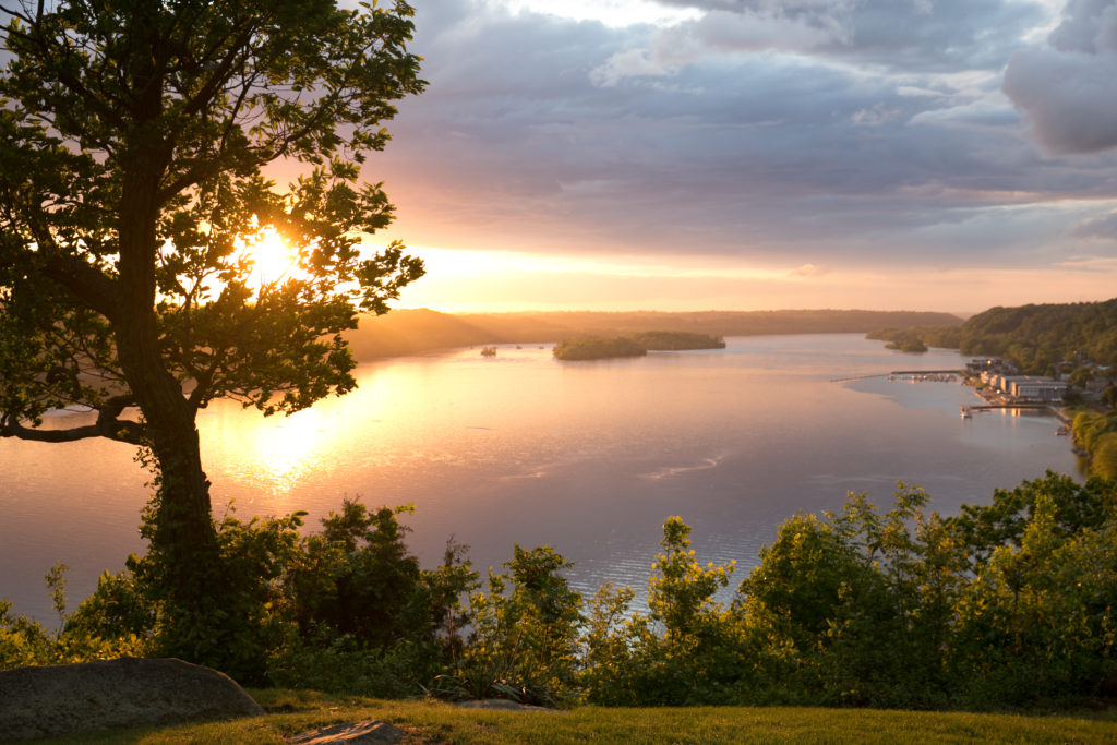 A view of the river with the sun setting in the distance